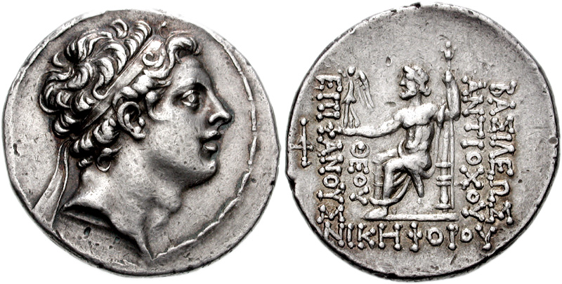 Silver coin of king Antiochus IV. Reverse shows seated Zeus holding Nike and scepter.